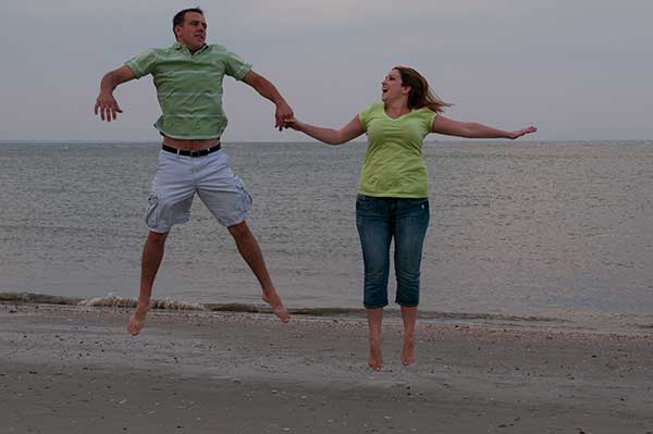 Jumping For Joy In Love Engaged Couple