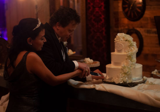 Bride And Groom Cutting Cake