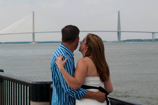 Couple Downtown Looking At The Ravenel Bridge