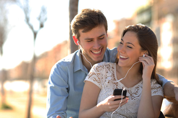 Engaged Couple Listening To Spotify For Wedding Music
